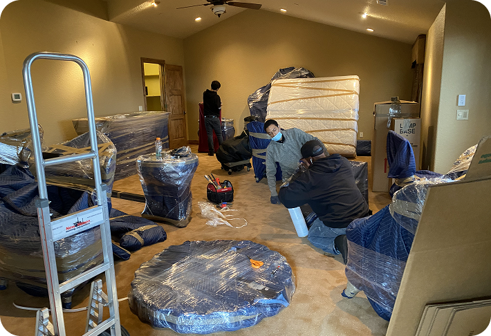 Residential moving crew wrapping mattresses and furniture for protection