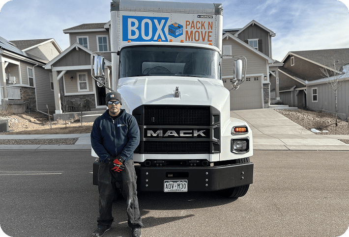Box Pack N Move mover standing beside a moving truck