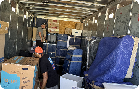 Long-distance movers loading furniture into a truck