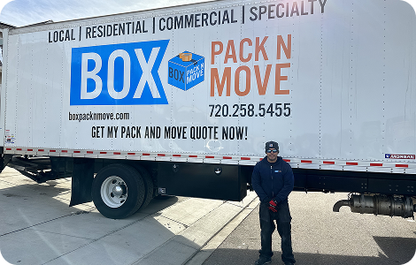 Long-distance mover beside a moving truck