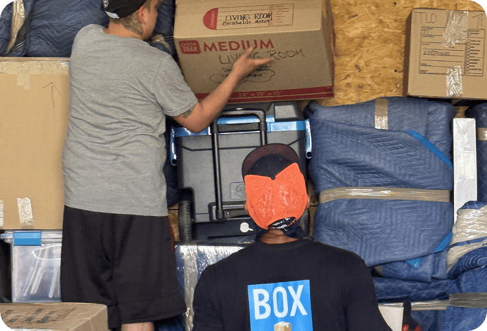 Moving crew stacking household boxes inside a truck