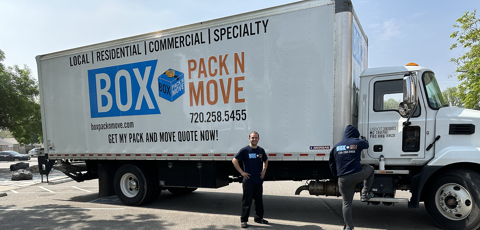 Interstate movers beside a moving truck for long distance relocation