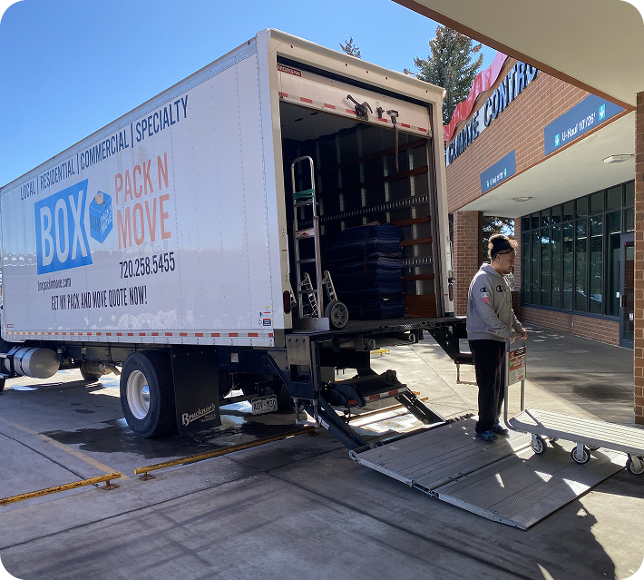 Castle Rock movers with a moving truck and loading lift