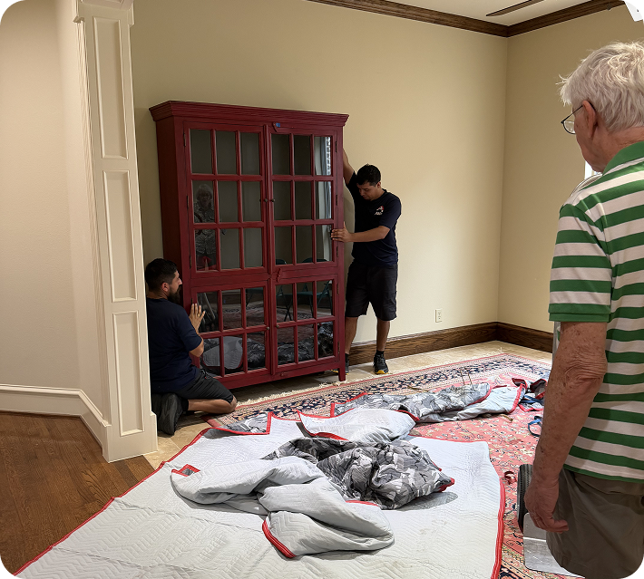 Lakewood movers handling a wooden display cabinet