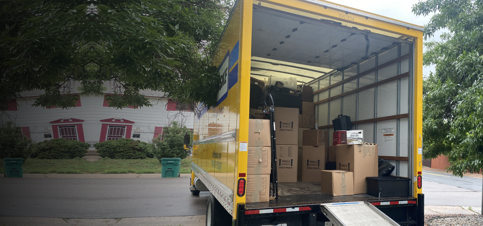 Pueblo movers loading wrapped furniture into a moving truck