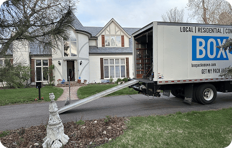 White-glove moving truck outside a home