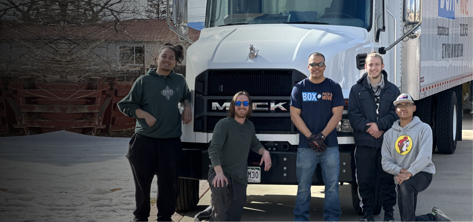 Box Pack N Move team standing beside a moving truck