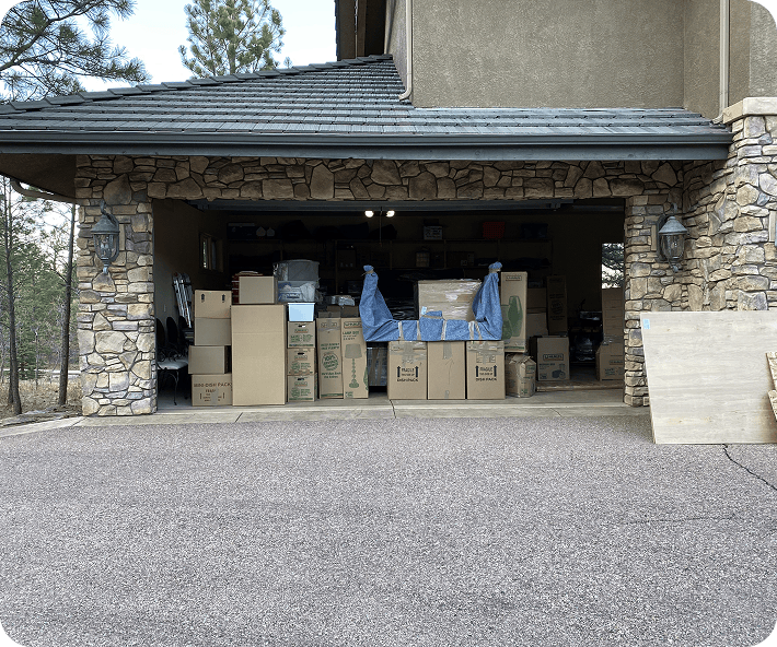 Movers clearing space with wrapped household furniture