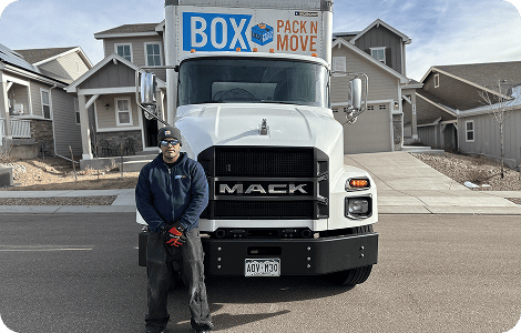 Residential mover beside a moving truck