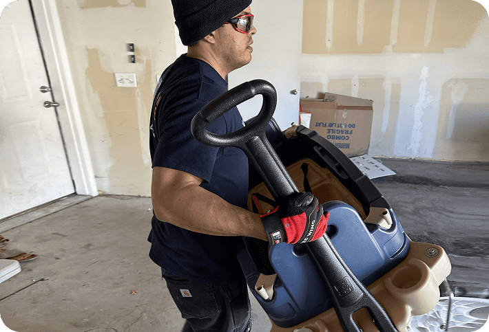 Professional mover carrying bulky exercise equipment