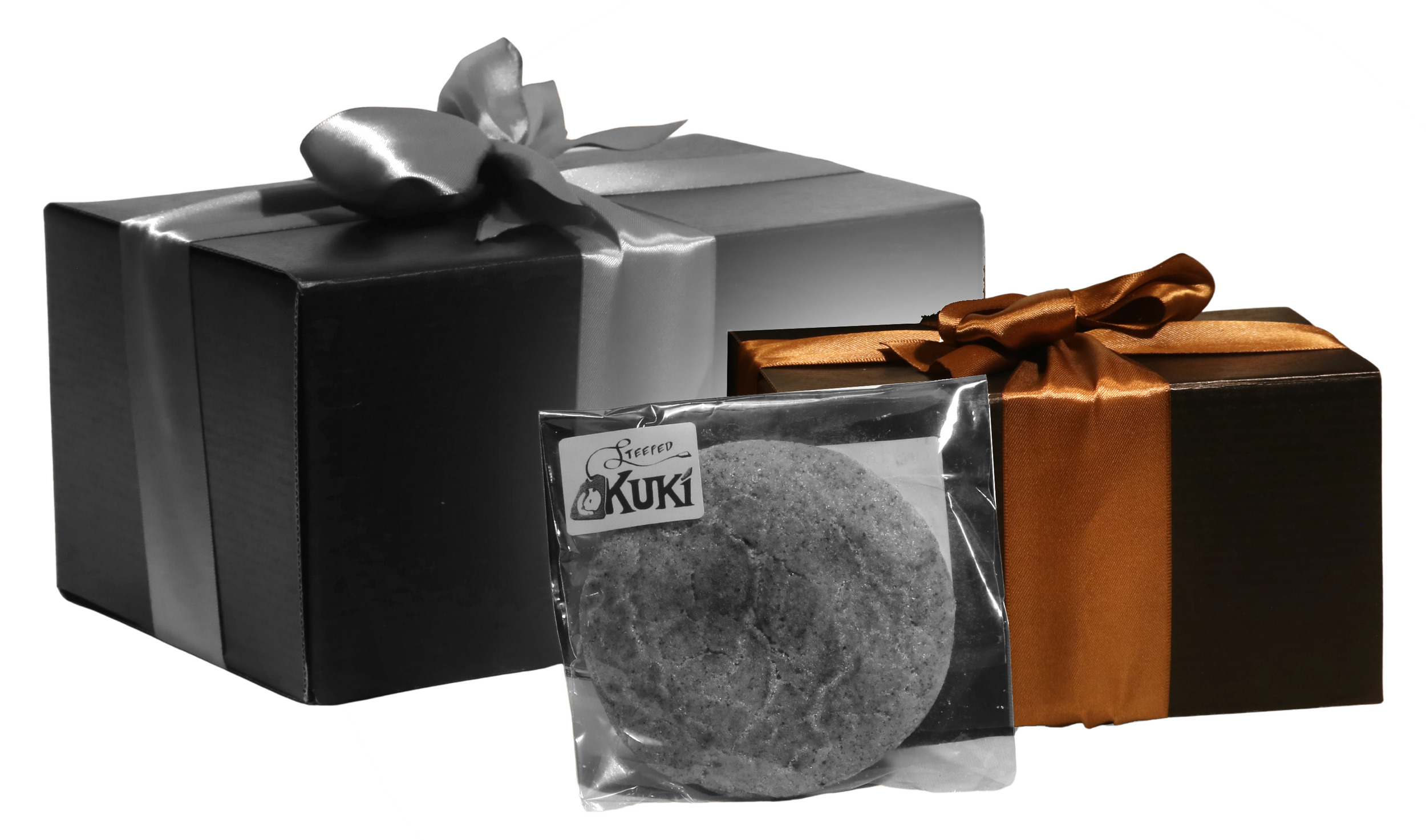 Black gift box with silver ribbon and bow, and orange gift box with orange ribbon and bow, along with a bag of Kuki steeped cookies.