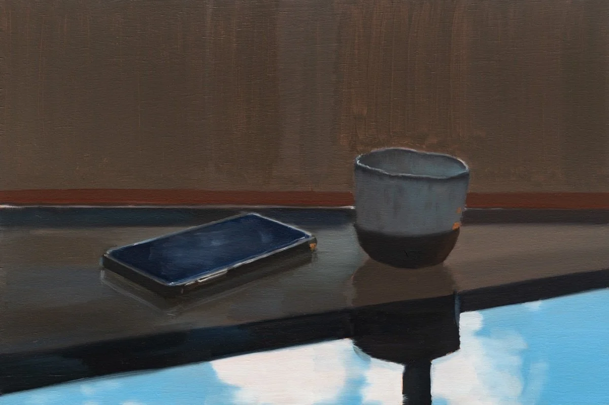 Phone, cup and reflected sky, 2023, oil on board, 26.5 x 40 cm