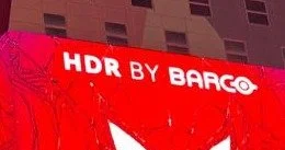 Corner detail of the Times Square building takeover showing the synchronized Spider-Man mask motif across both screens