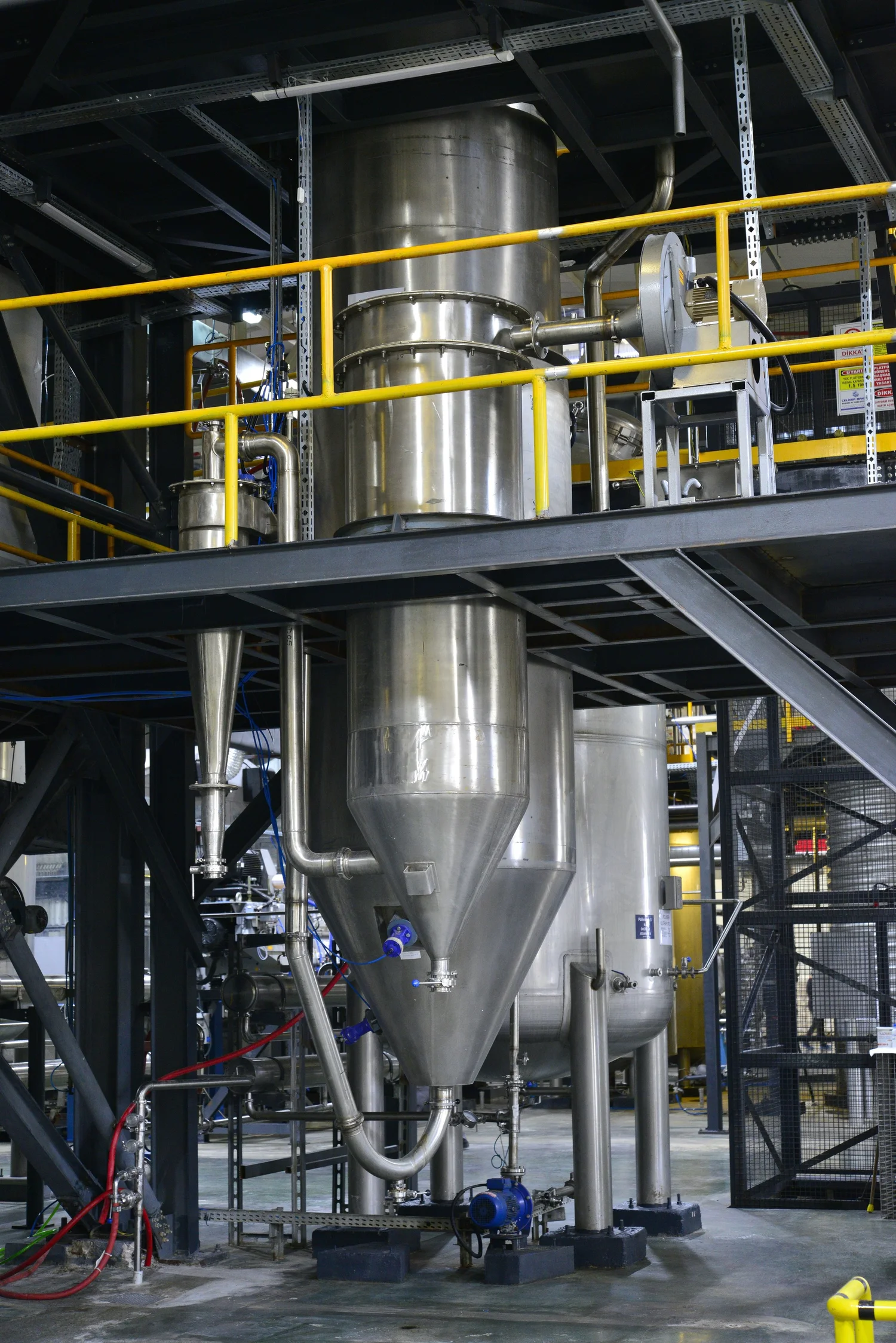 The stainless steel tower of Livzym's industrial spray dryer with its access platform