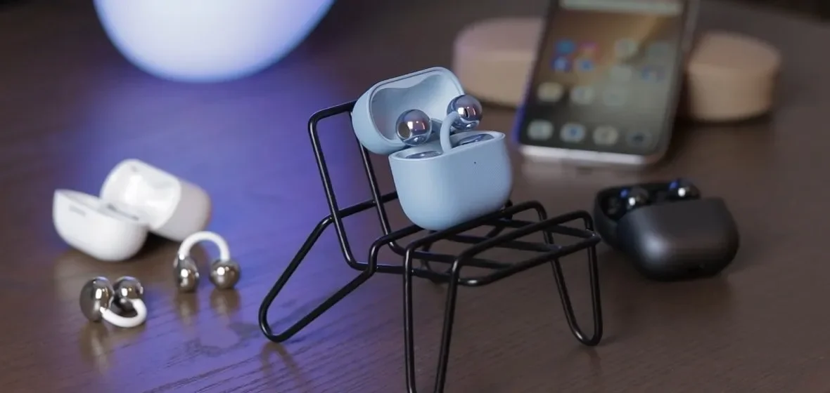 Huawei FreeClip 2 earbuds in all colors on a stand
