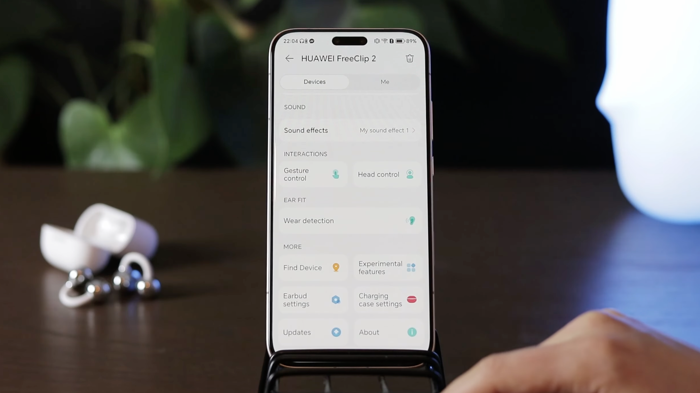 An iPhone with a Huawei Audio Connect App open showing features like sound effects, gesture control or find device