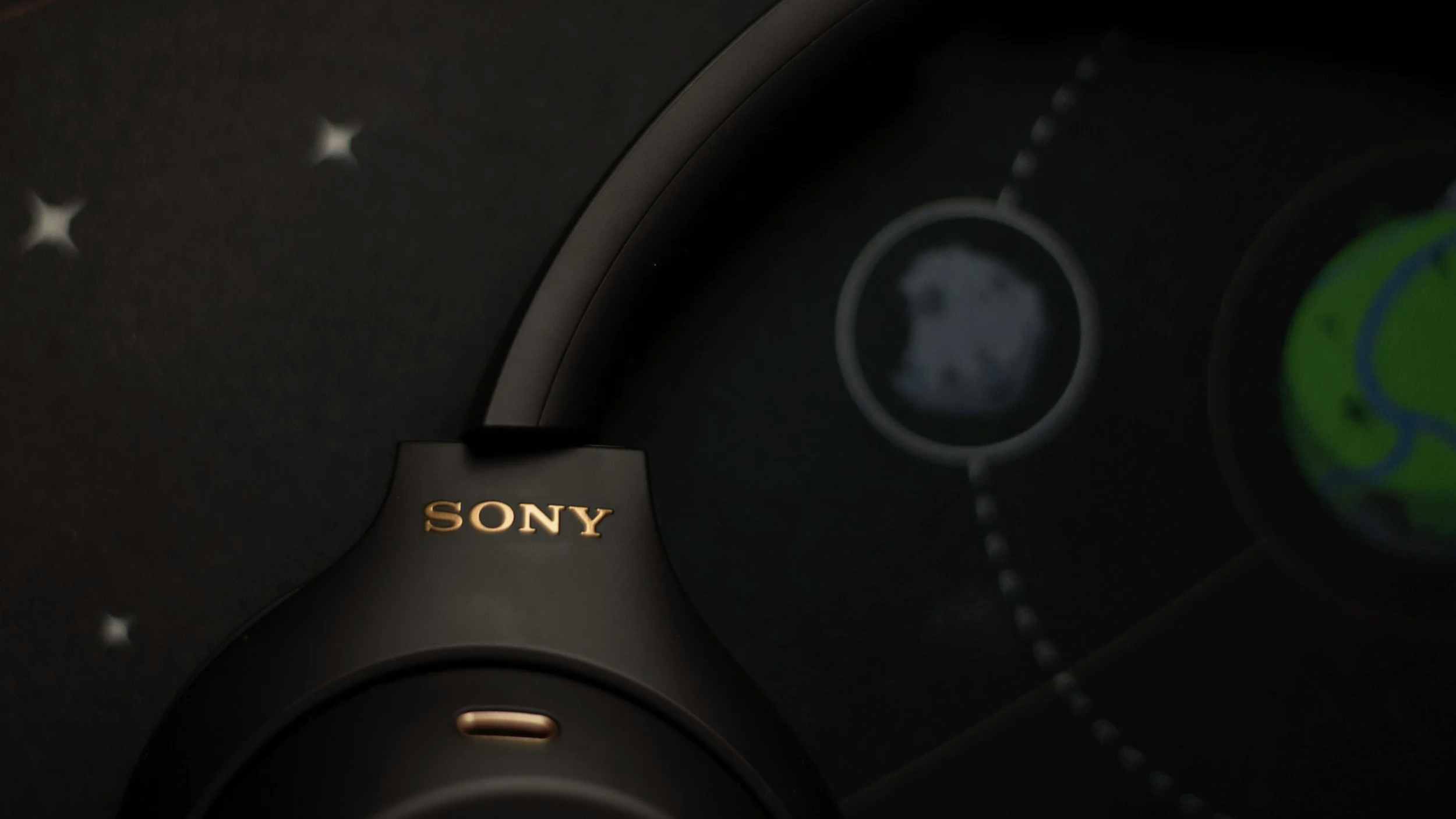 Dark Sony headphones with a golden Sony logo