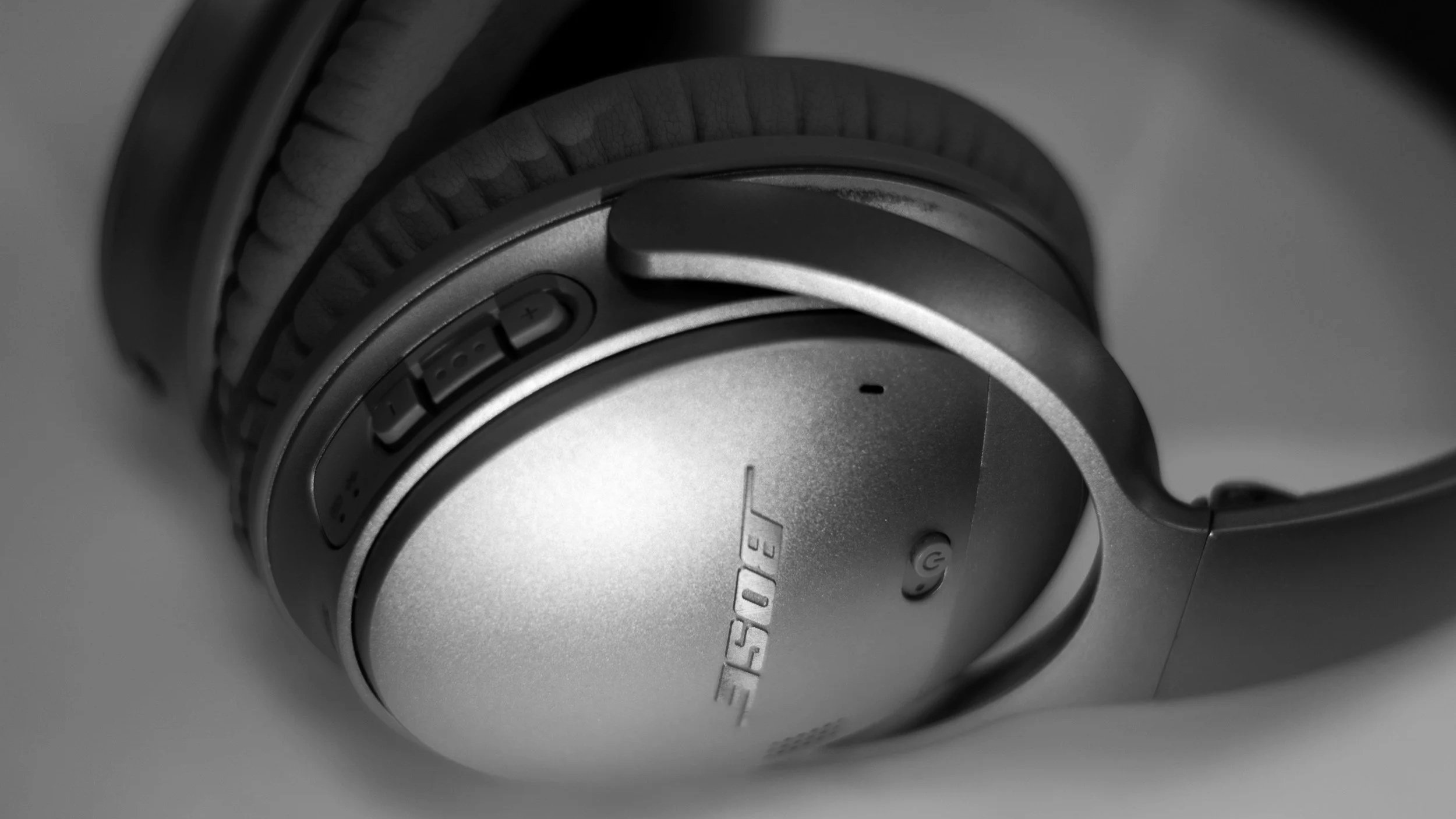 Dark Bose headphones laying on the side