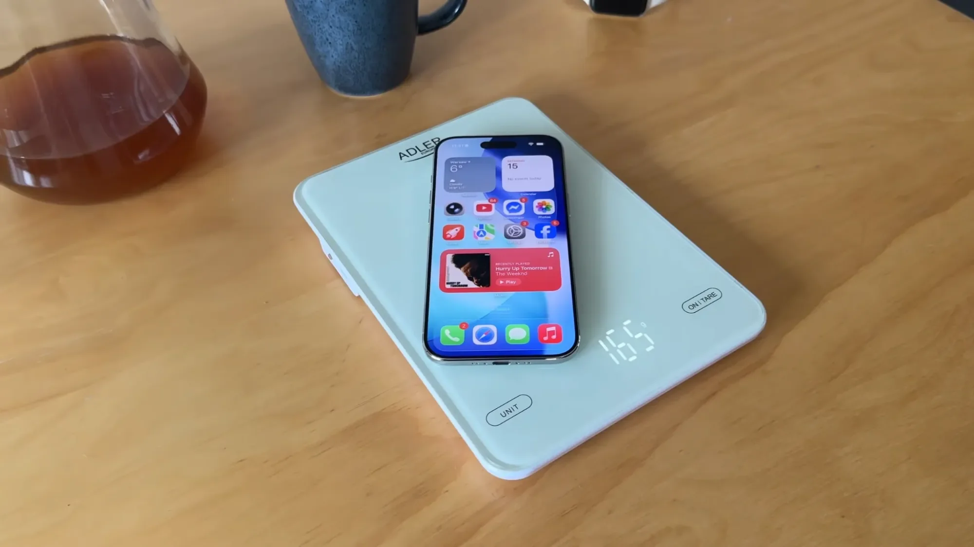 iPhone Air lying on a light blue tray on a wooden table