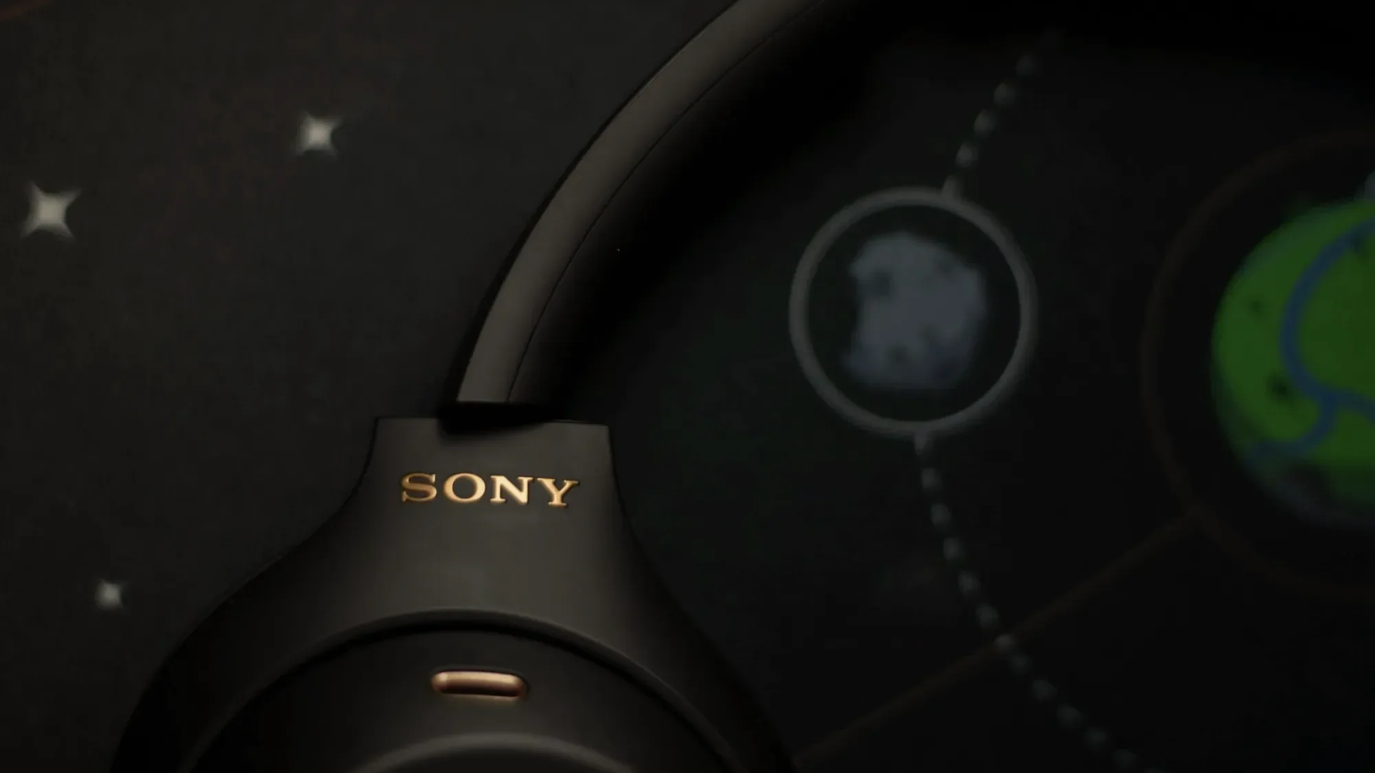 Close-up of black Sony headphones with a gold logo