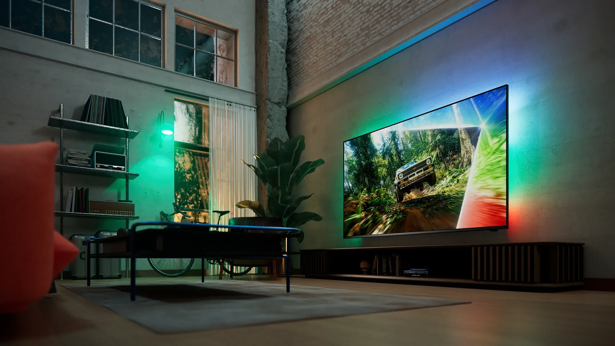 Philips MLED981 Mini-LED TV with Ambilight glowing in a loft apartment