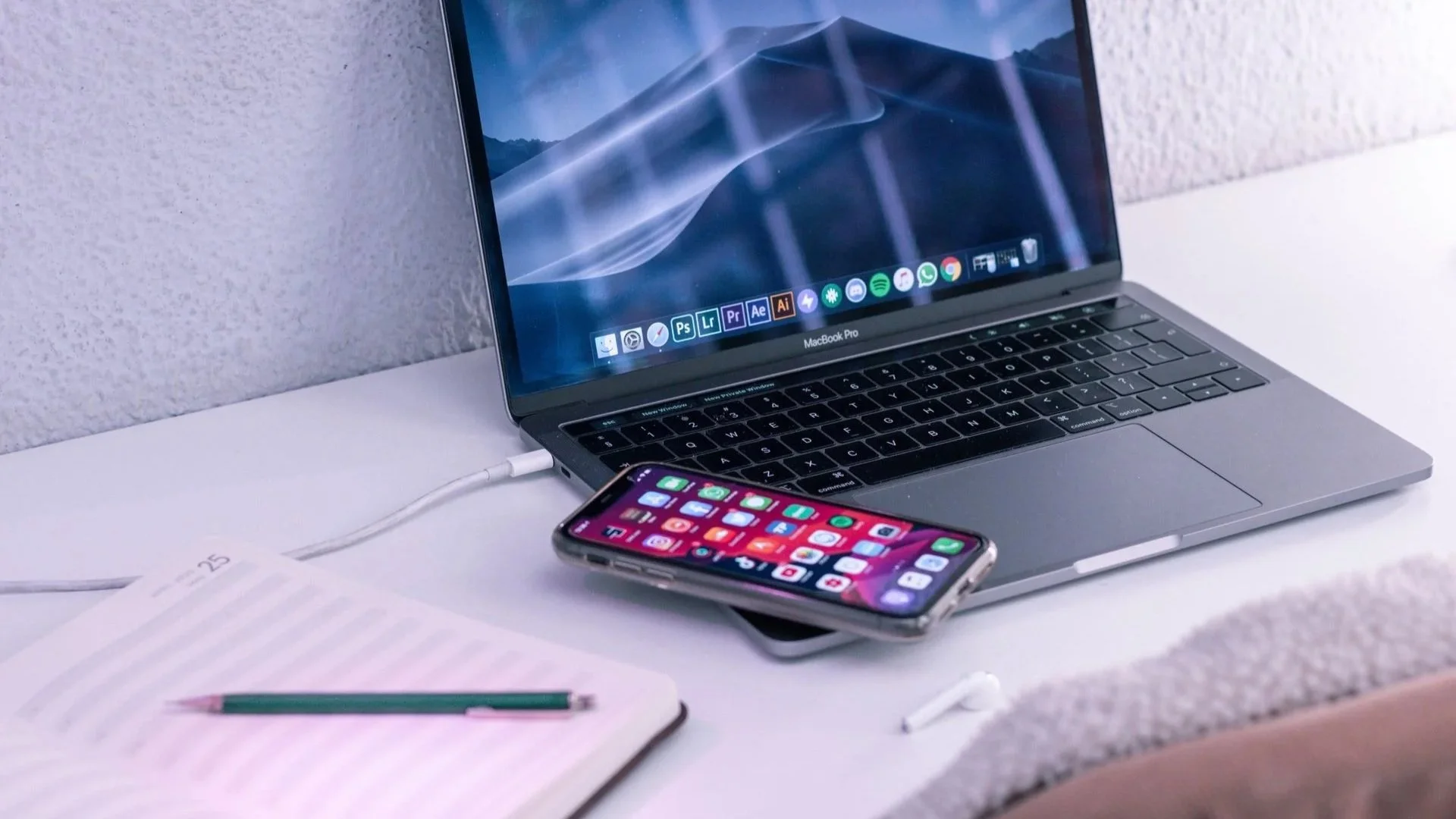 an iPhone laying on a MacBook Pro