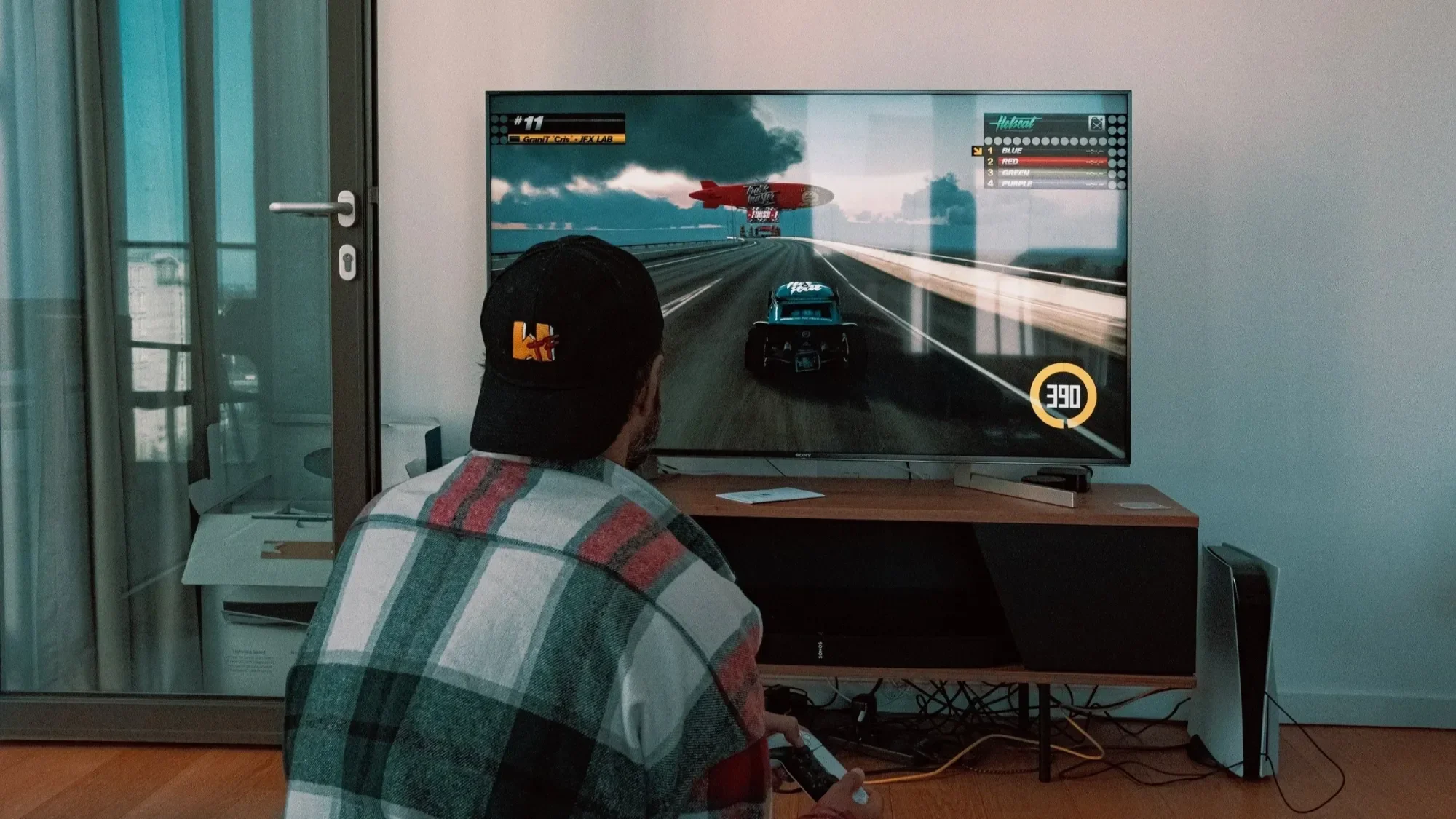 Person sitting on the floor watching a big TV