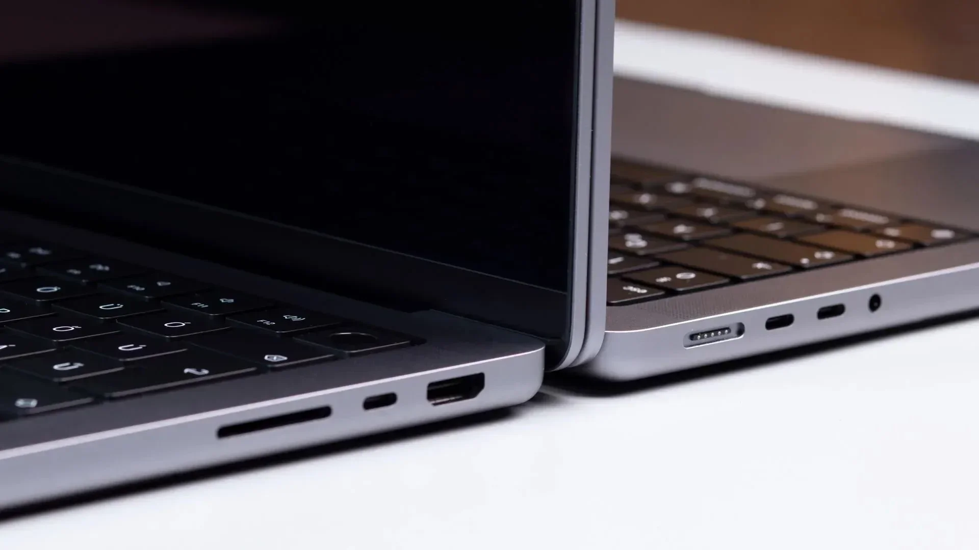 Close-up of the ports on the sides of two MacBook laptops