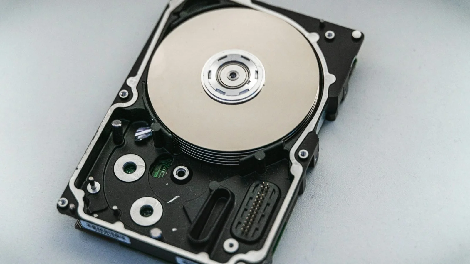 Open hard drive showing the disk platter used in NAS and backup storage