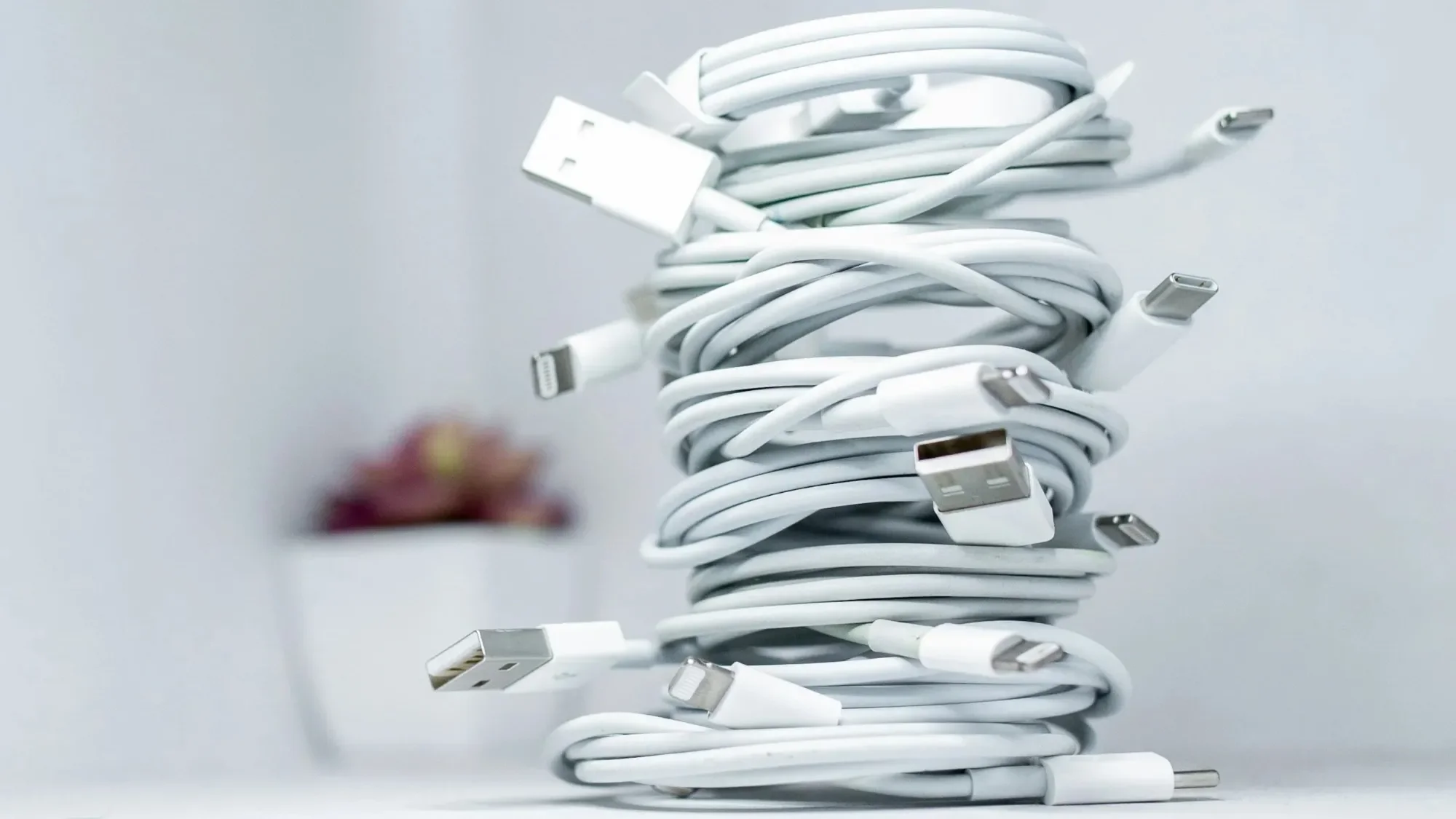 Stack of coiled white USB charging cables