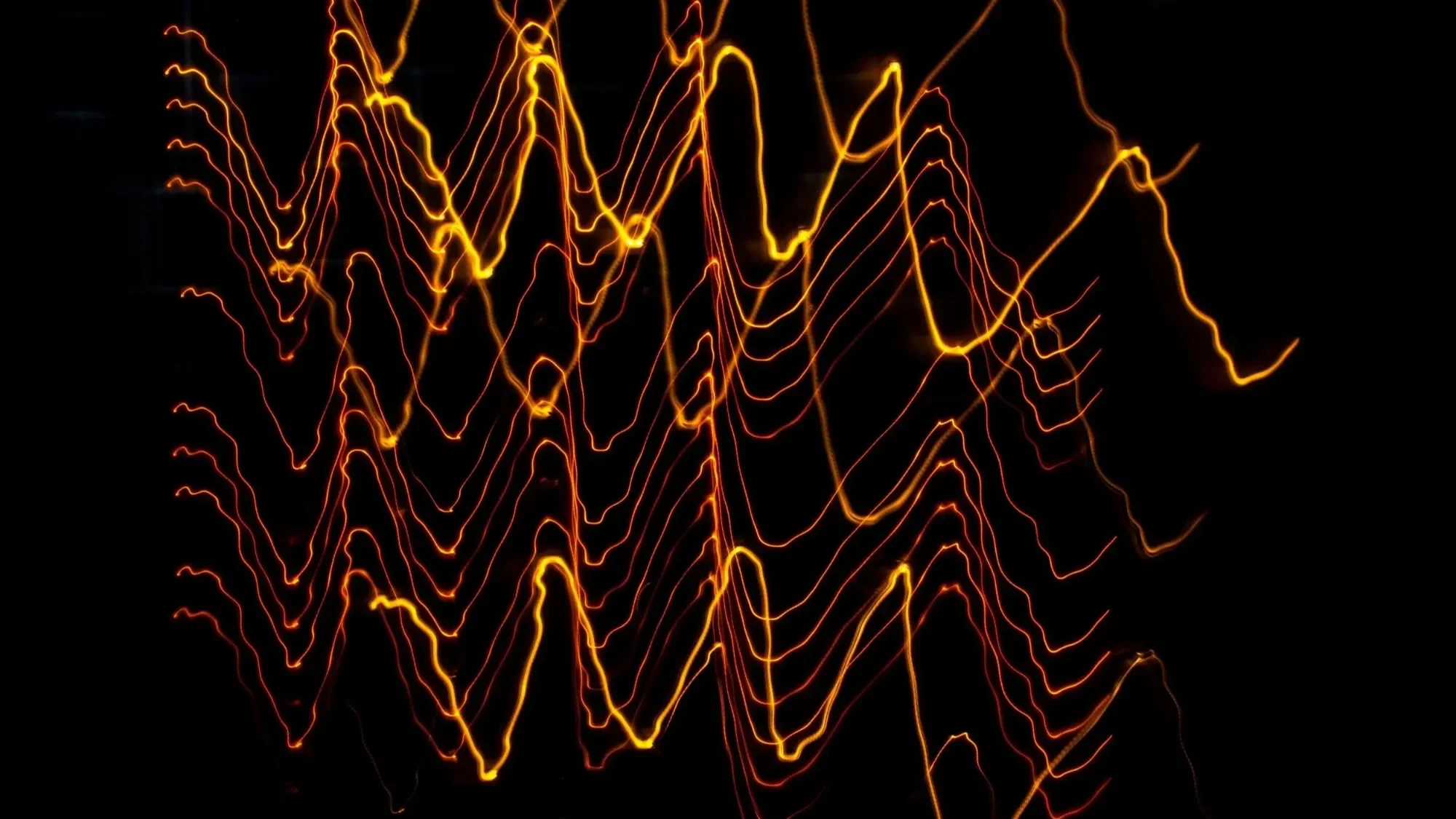 Visualization of orange sound waves on a black background