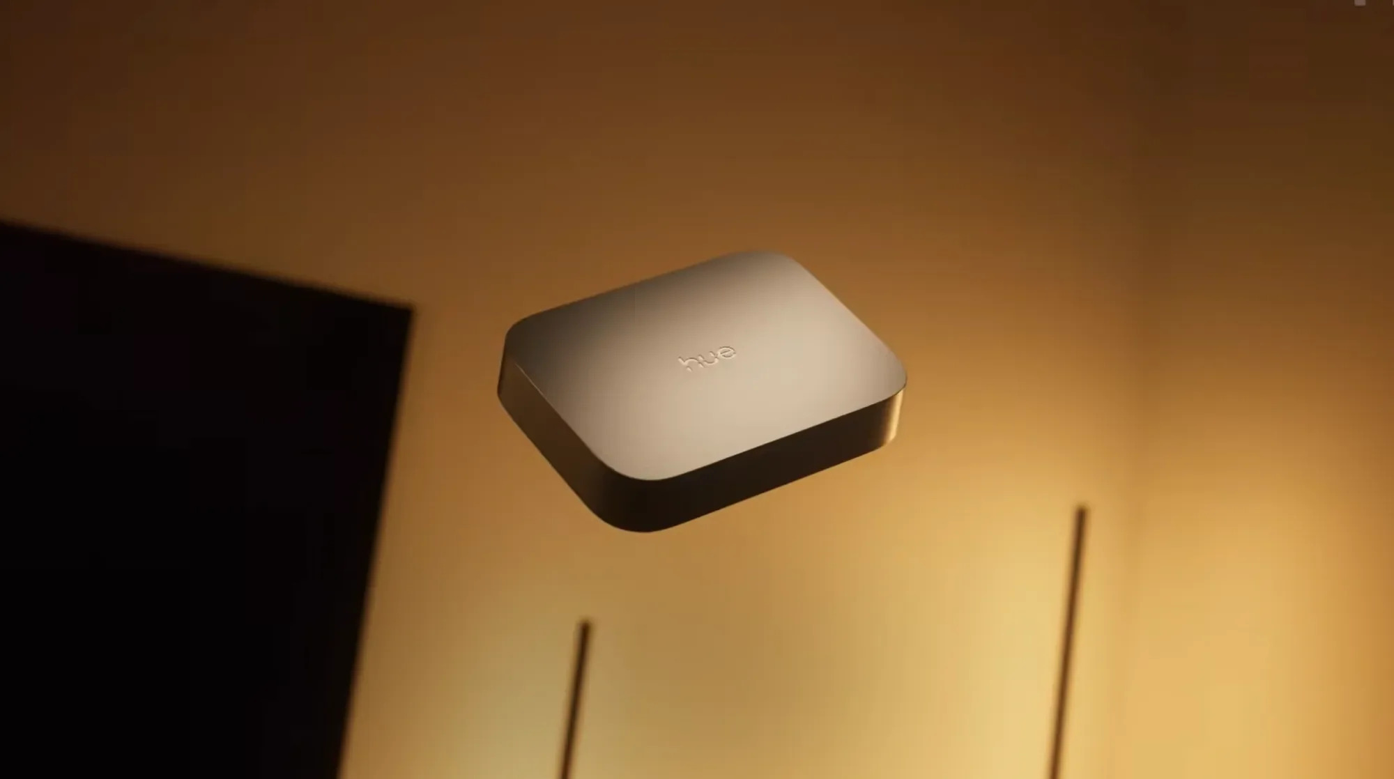 White HDMI light sync box casting warm light onto a wall