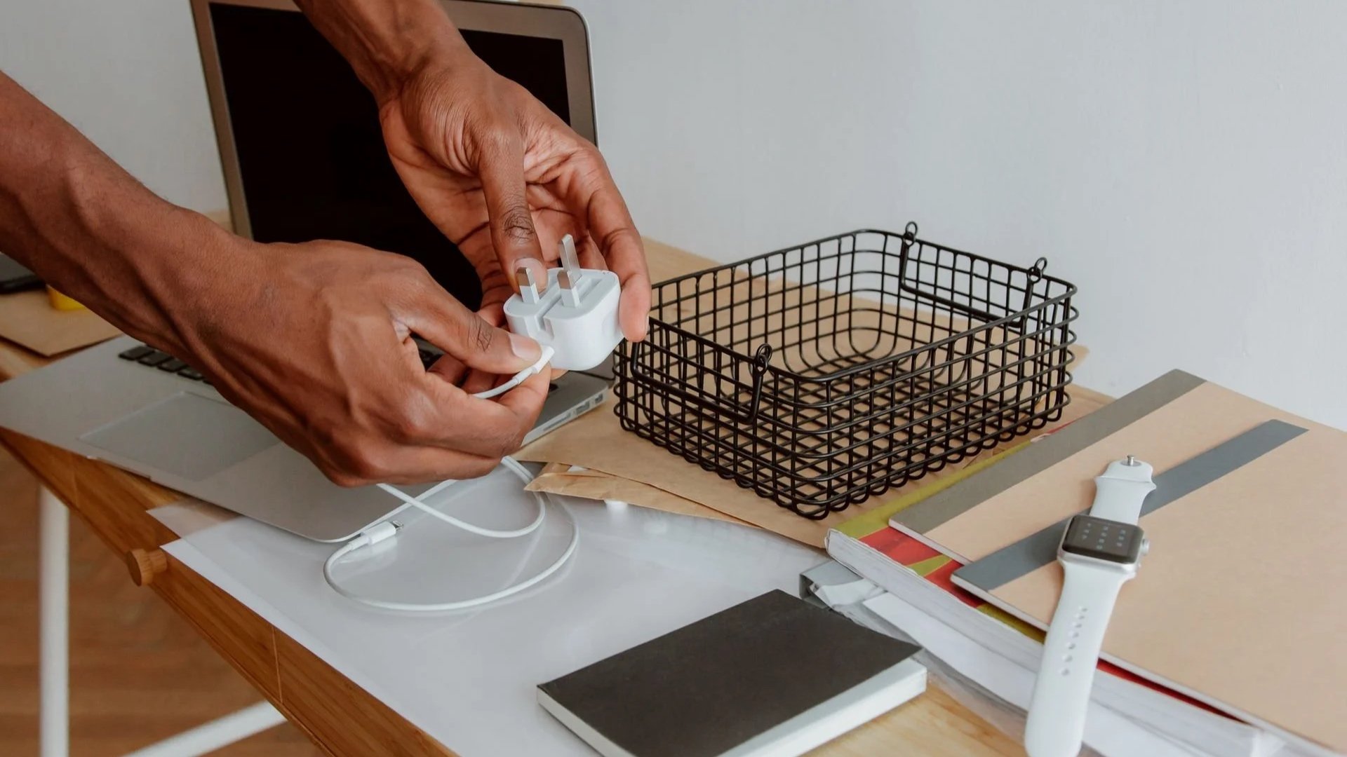 a laptop charger held by a man