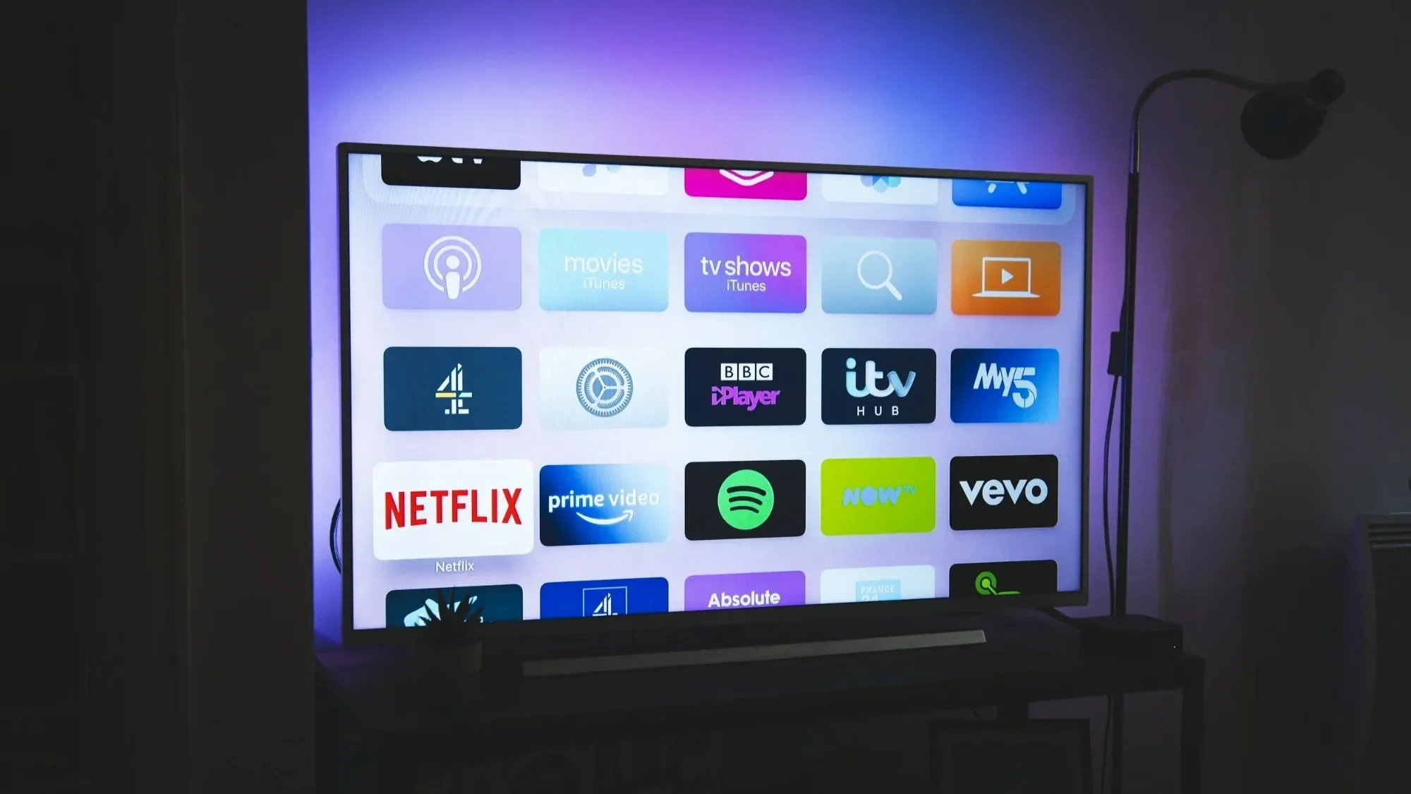 Smart TV home screen with streaming apps in a dark room