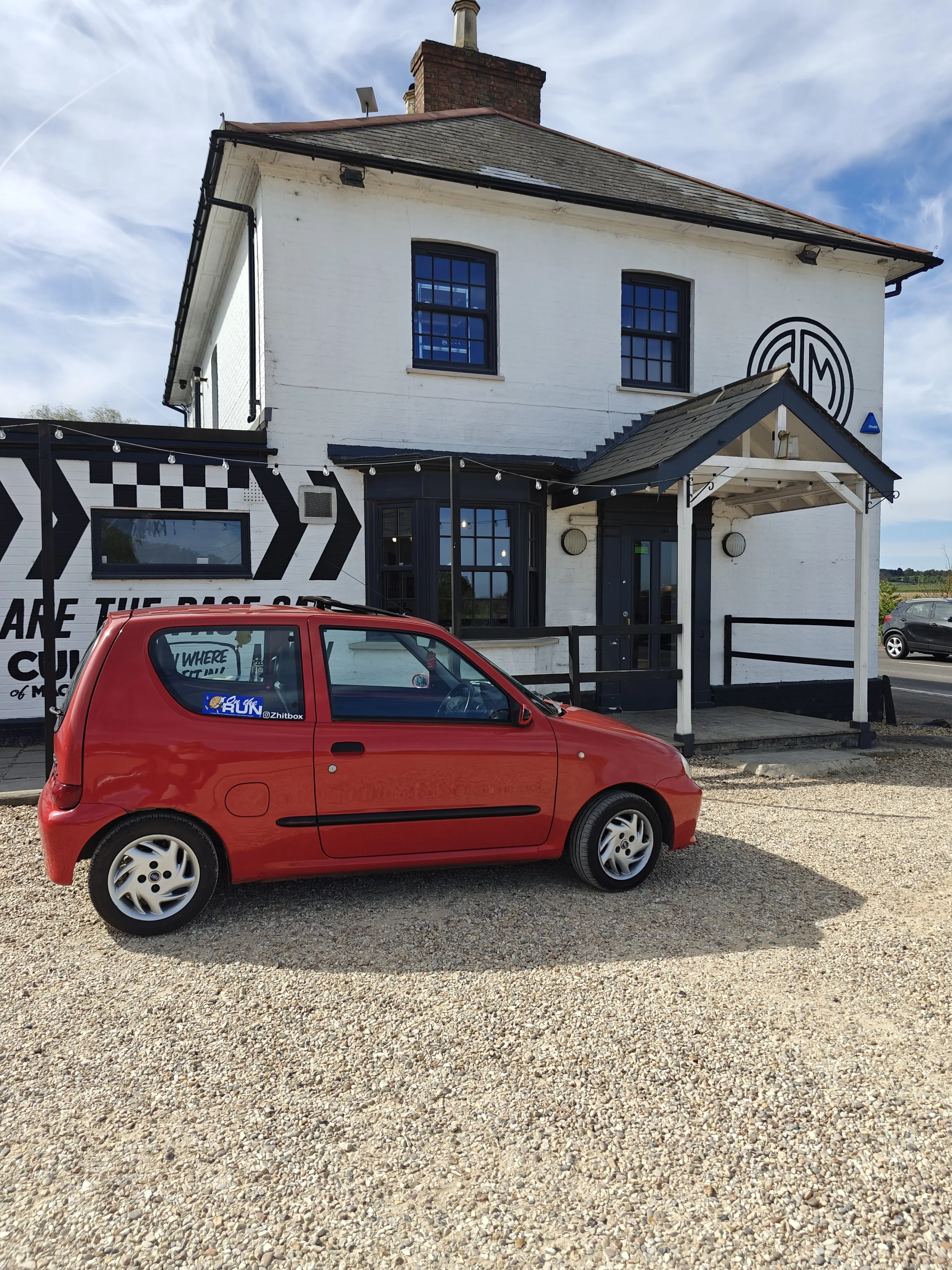 Red Fiat Seicento outside Caffeine and Machine The Bowl