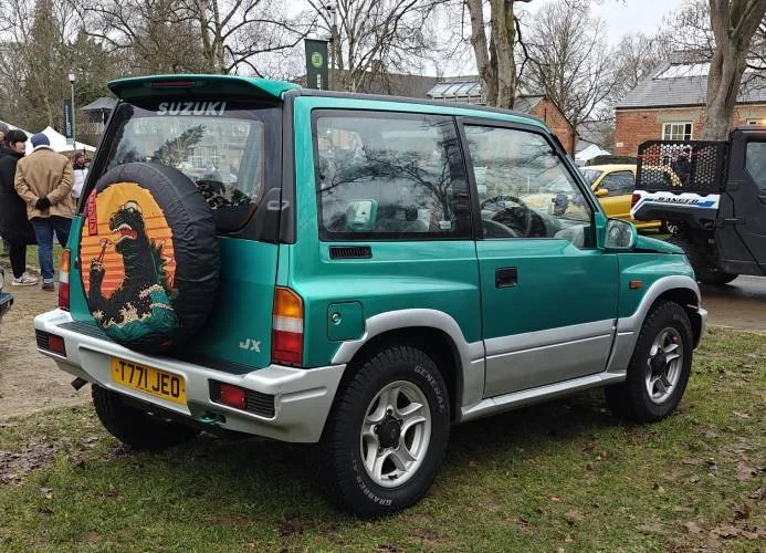 Green 90s Suzuki Vitara with Godzilla wheel cover