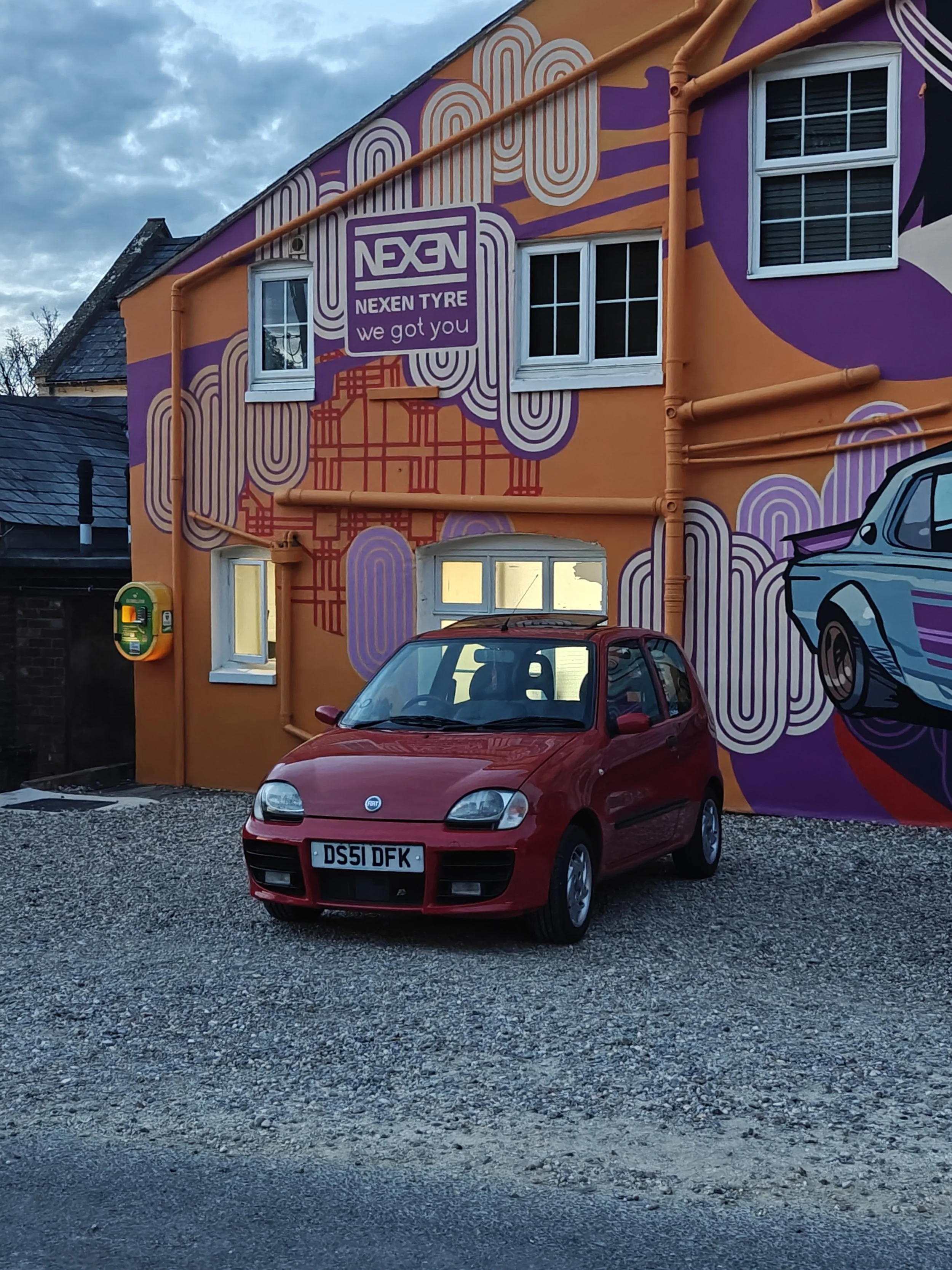 Red Fiat Seicento outside mural at Caffeine and Machine The Hil