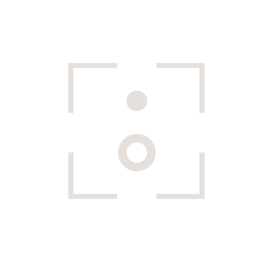 A camera viewfinder focusing on two circular objects, one smaller above a larger, ring-shaped one, within a square frame.