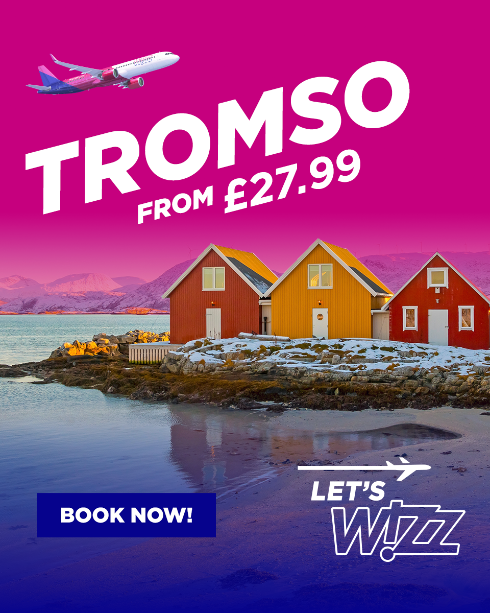 Bright pink promotional poster advertising trips to Tromsø, with a colorful cityscape, houses by the water, an airplane flying in the sky, and text promoting prices from £27.99 and a call to action for booking.
