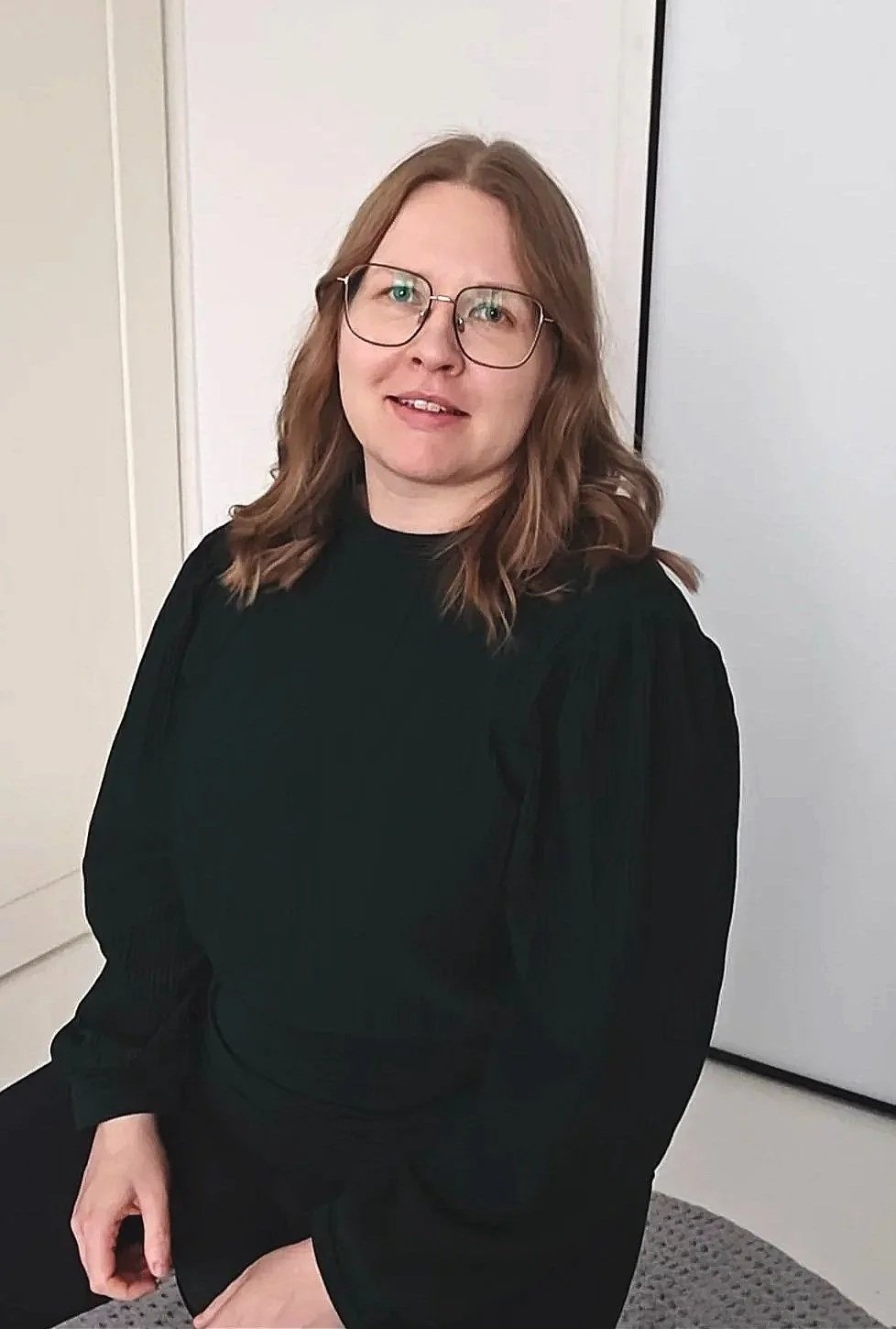 Tilitoimisto Lojalan yrittäjä Annakerttu Kivelä istuu tuolilla toimistossa.
