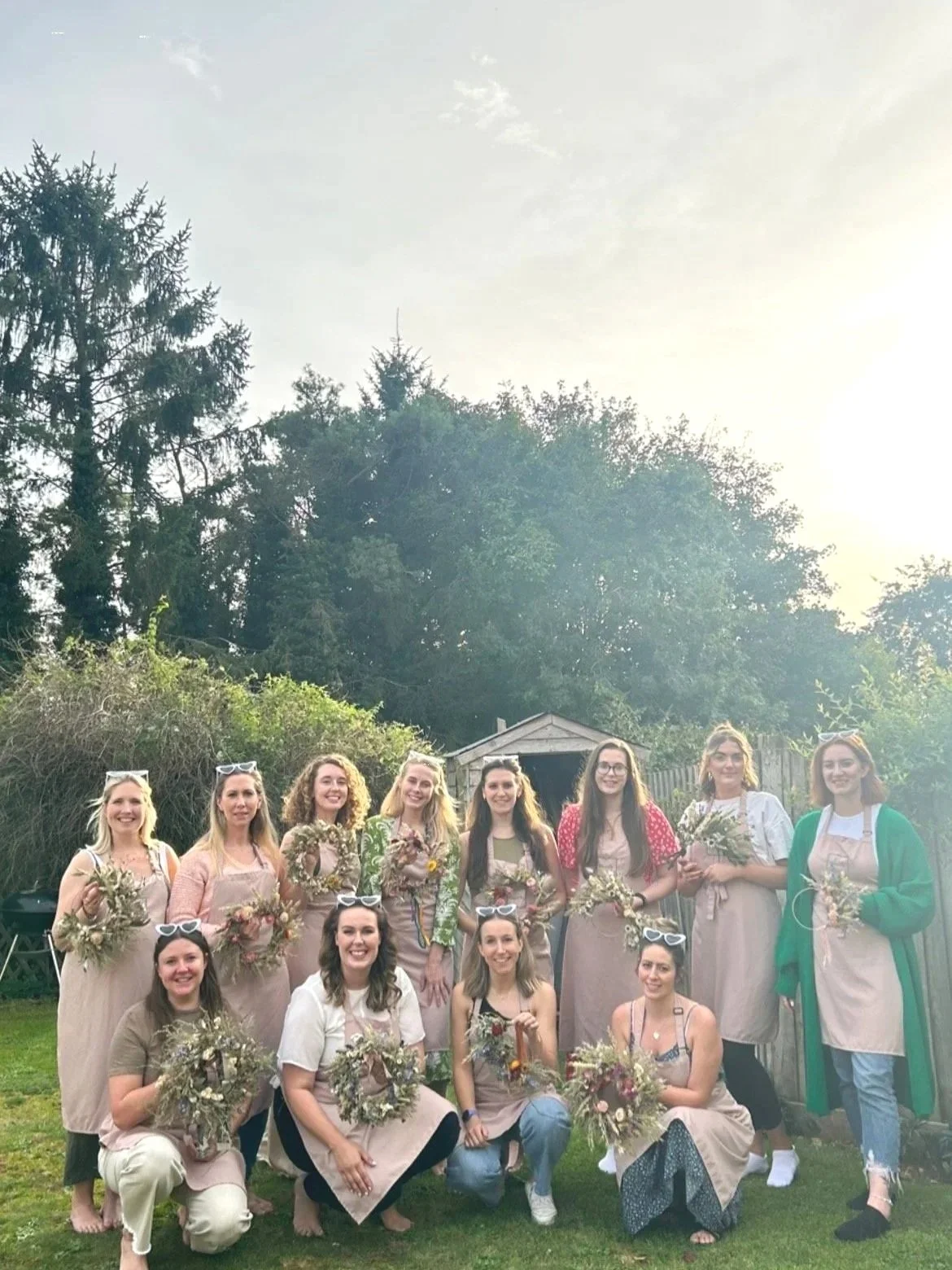 A hen party group photo to show the dried flower wreaths they have created.