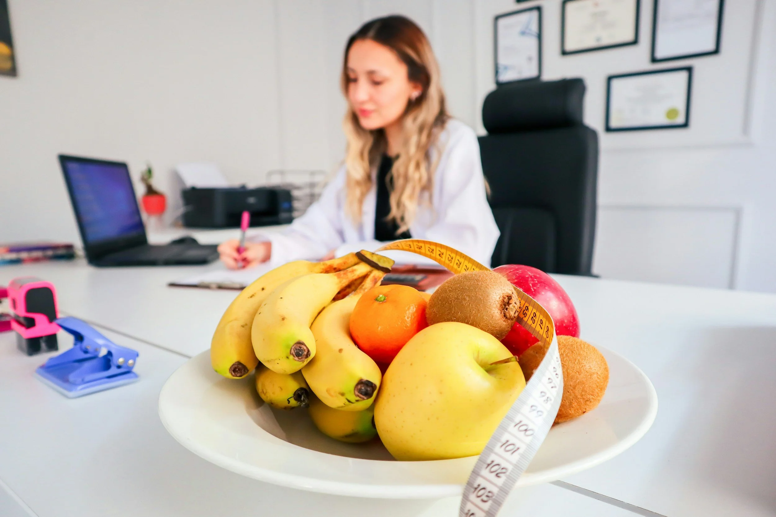 Fresh fruits and measuring tape representing medical weight managment.
