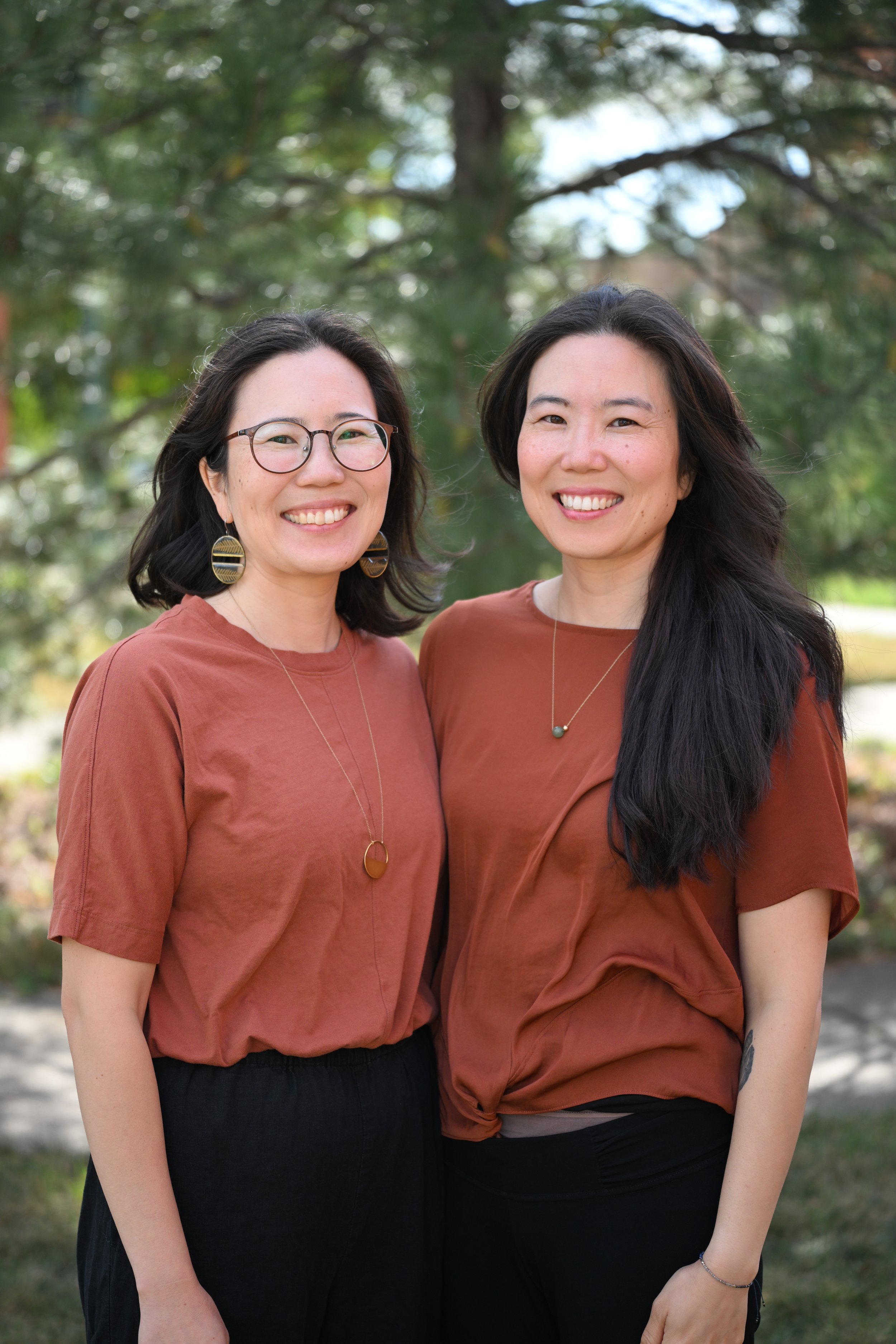 Felise Park and her twin sister Gi-Ae, co-founders of Maru, smiling side by side outdoors.