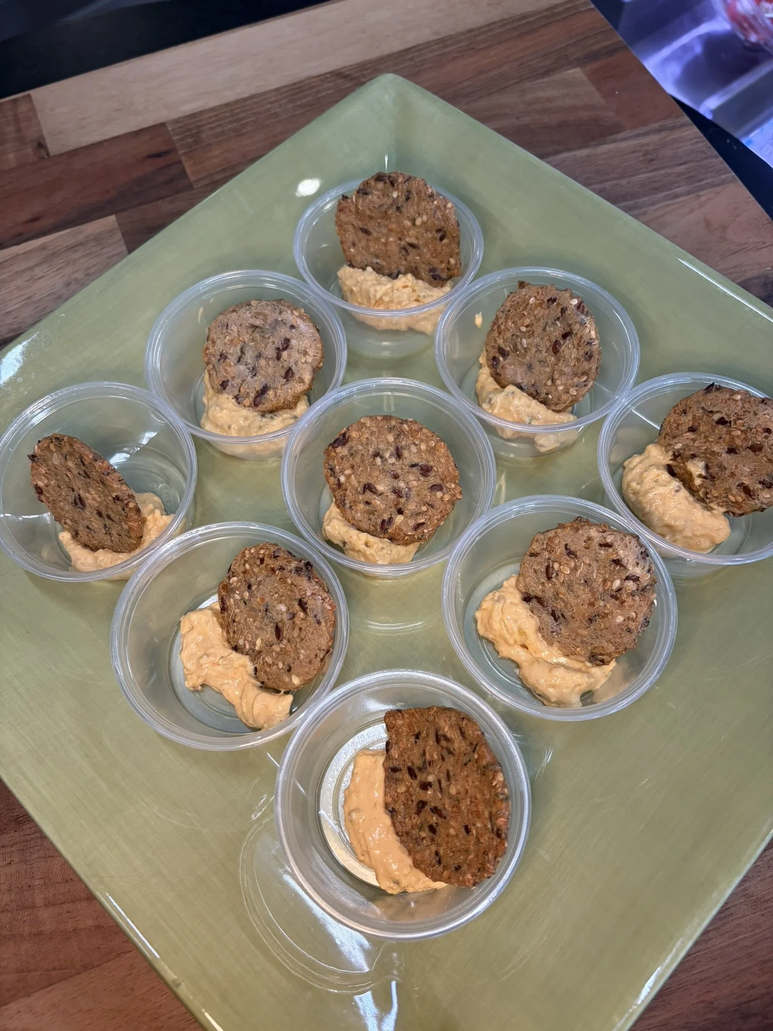 Multiple food samples arranged on a green tray.