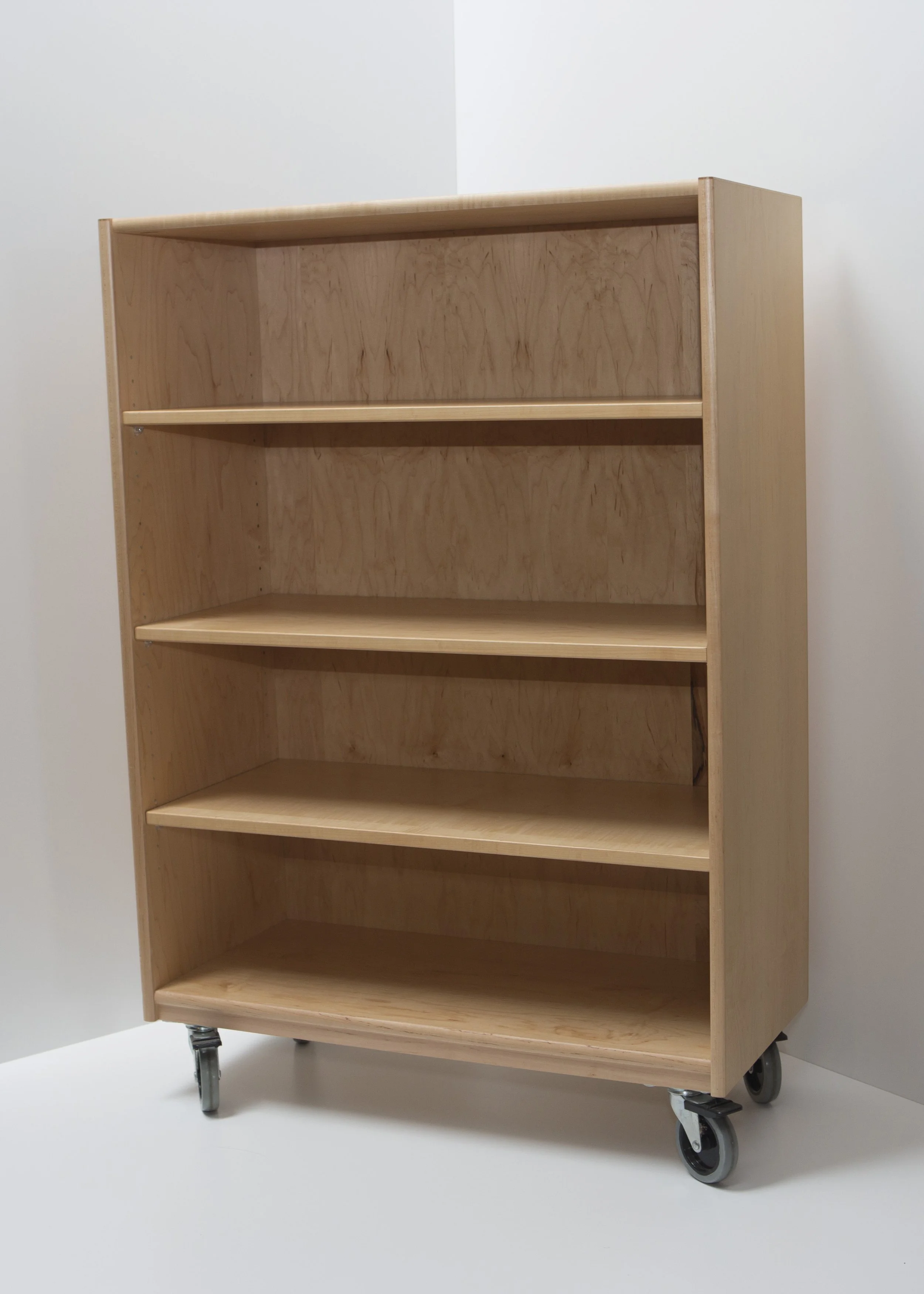 Empty wooden bookshelf on wheels set against a plain white background.