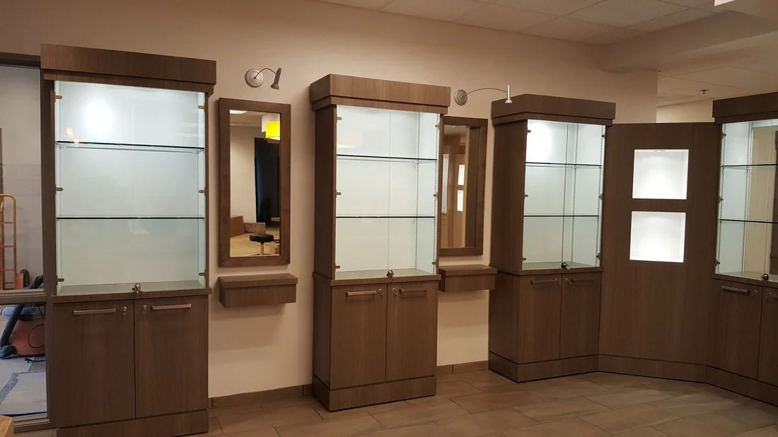 Display cases and mirrors in a retail store or showroom.