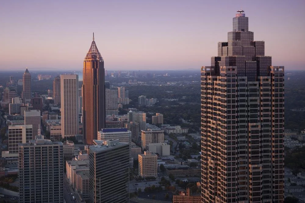 Skyline of Atlanta, Georgia, featuring tall skyscrapers with a sunset sky.