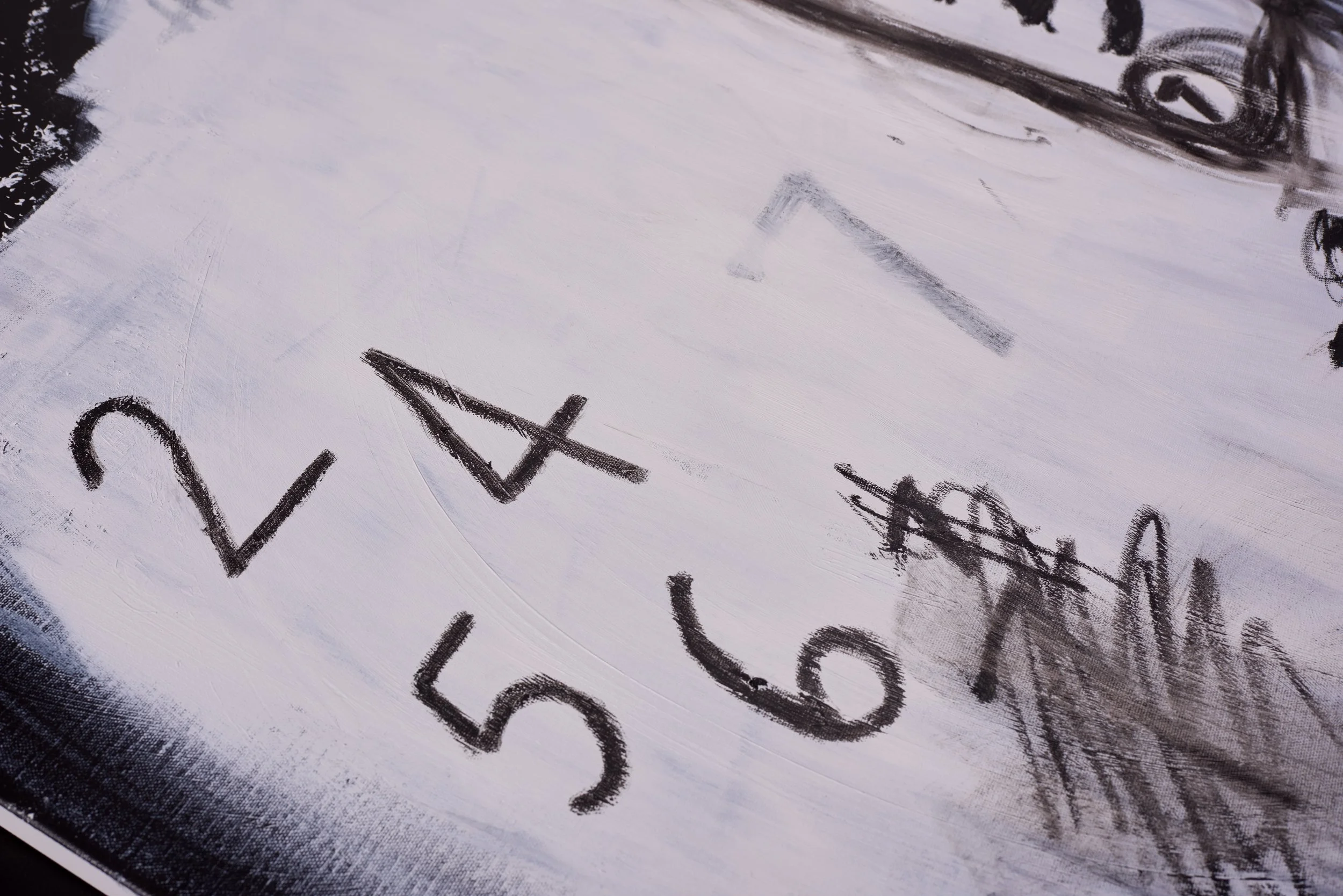 Close-up of a white surface with black handwritten text that says "say" and "who?" in a casual style.