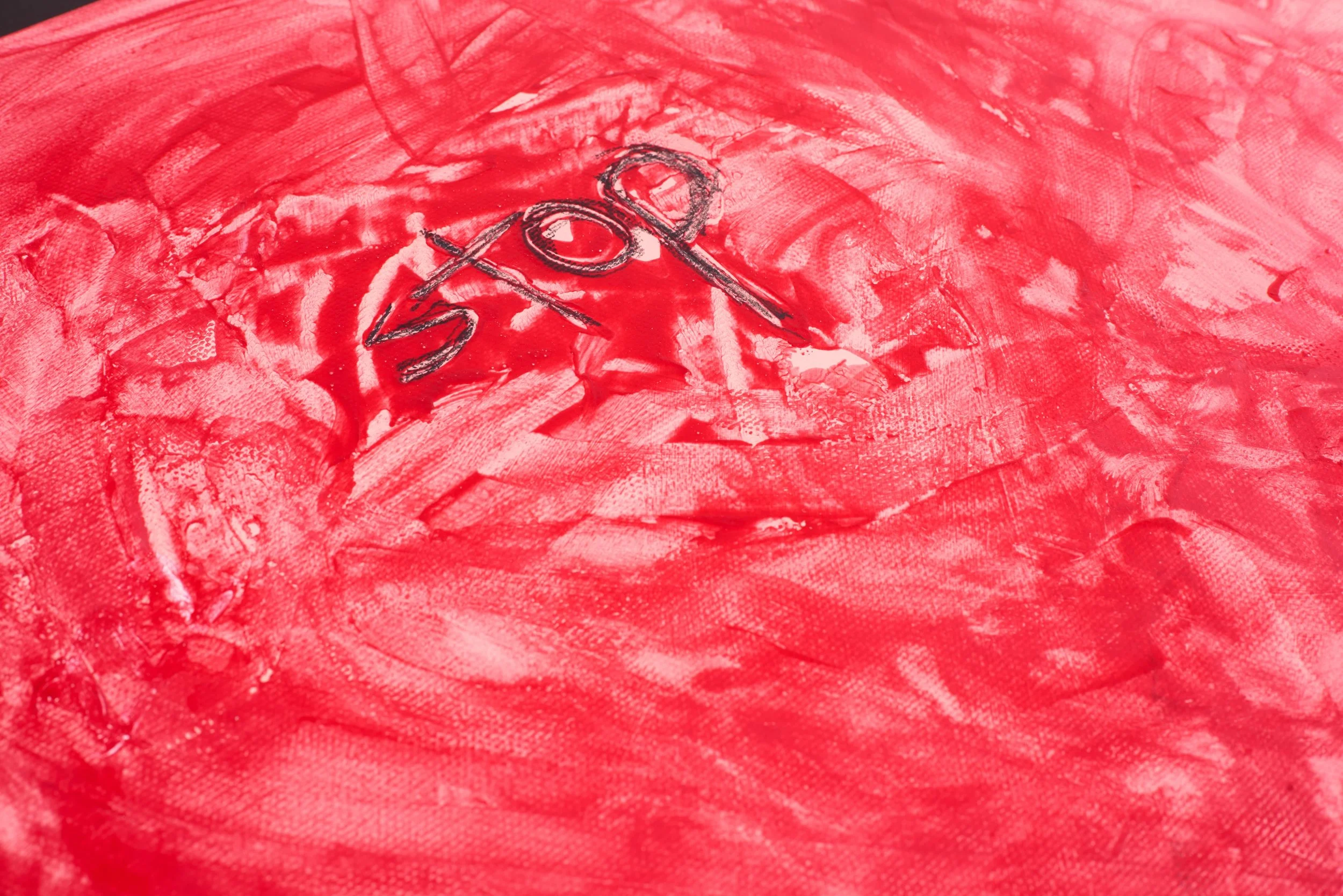 Red abstract painted background with black handwritten text reading 'stop'.