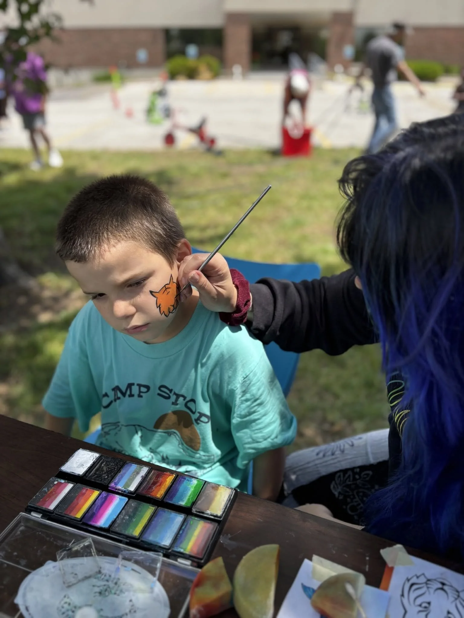 Developmentally disabled kid getting facepainted in Kansas City